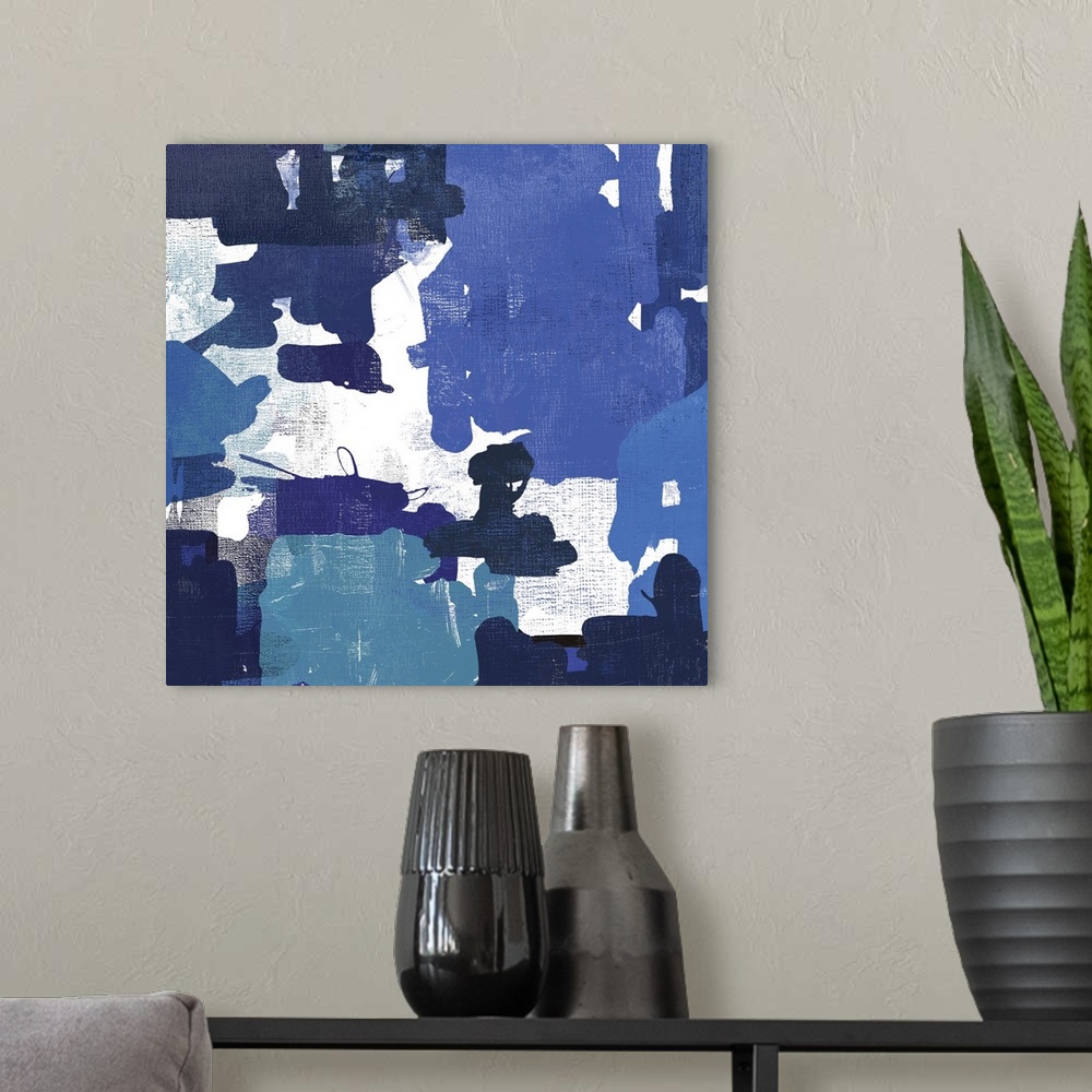 A modern room featuring A contemporary painting of abstract shapes in varies shades of blue.