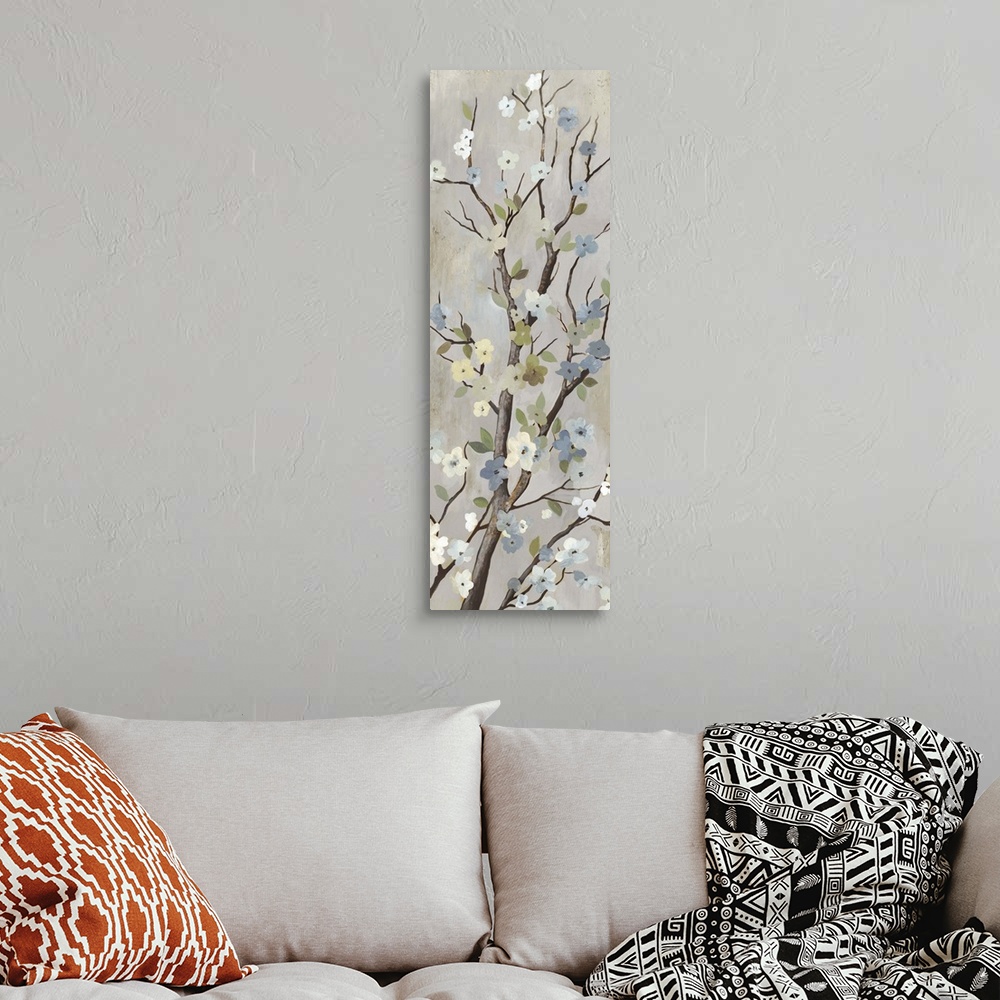 A bohemian room featuring Contemporary home decor artwork of a tree branch with white flowers in bloom.