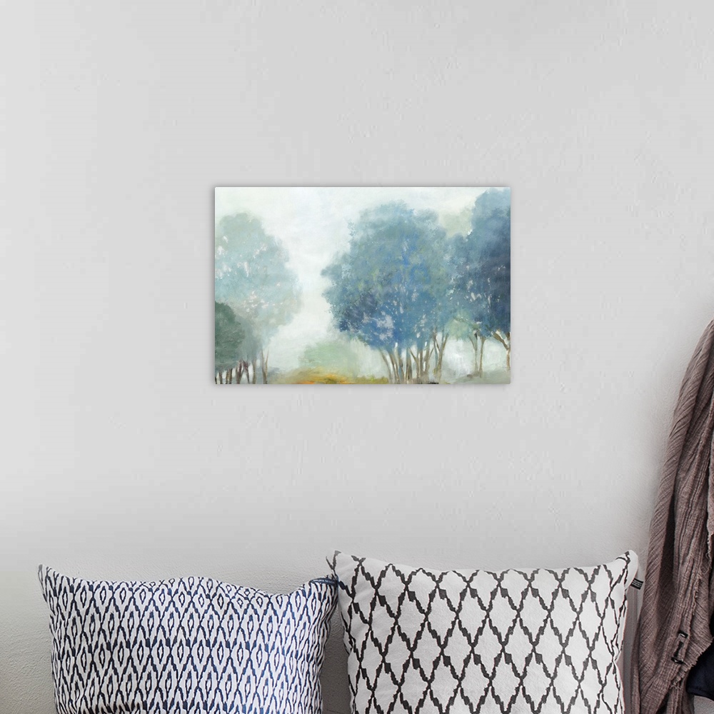 A bohemian room featuring Contemporary artwork of a misty valley with blue trees.