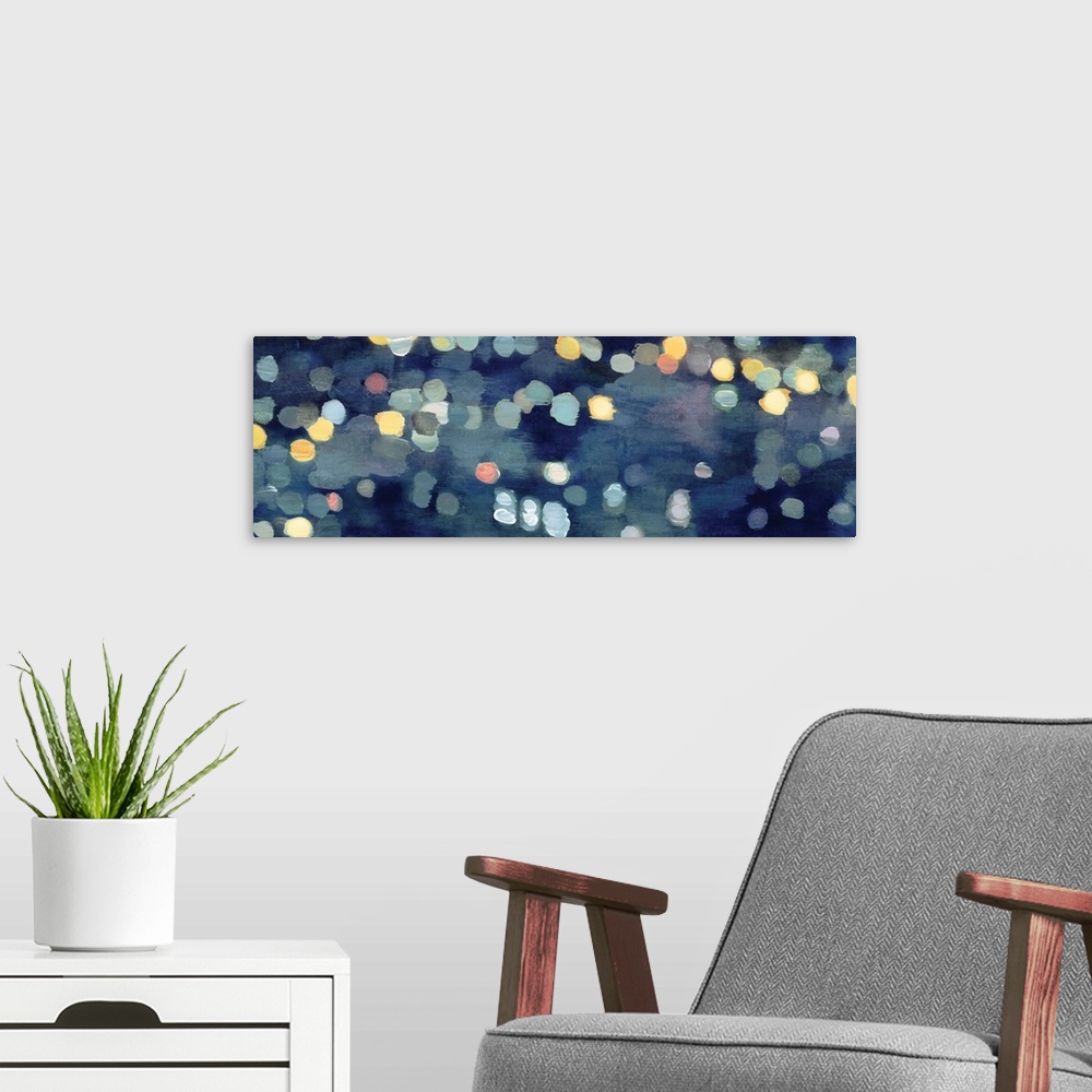A modern room featuring Abstract artwork in dark blue with gold and yellow shapes resembling blurred lights at night.
