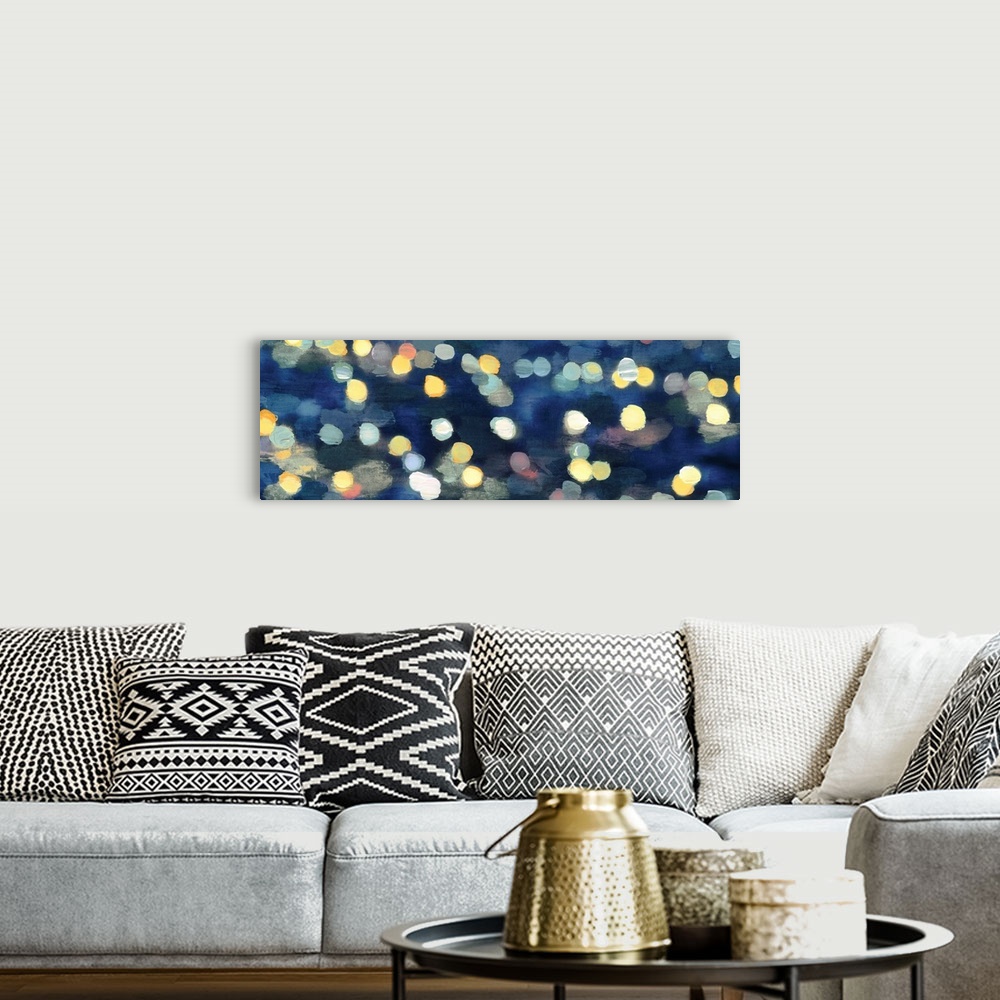 A bohemian room featuring Abstract artwork in dark blue with gold and yellow shapes resembling blurred lights at night.