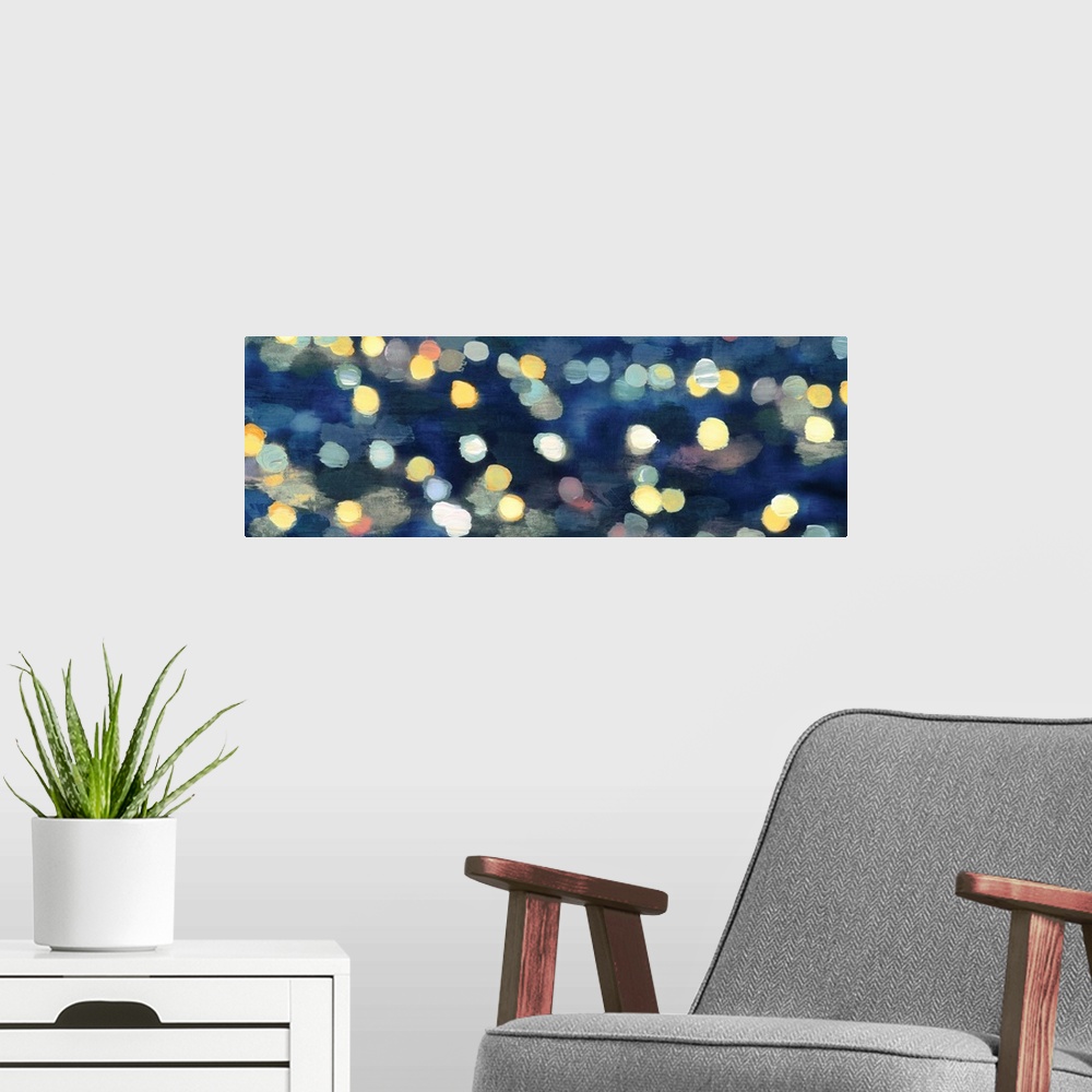 A modern room featuring Abstract artwork in dark blue with gold and yellow shapes resembling blurred lights at night.