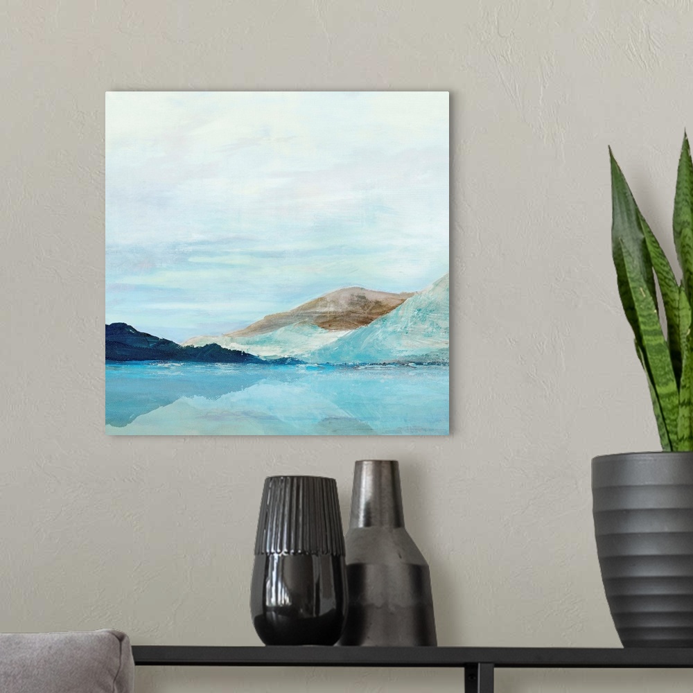 A modern room featuring Square painting of rolling mountains along a lake with a clear blue sky.