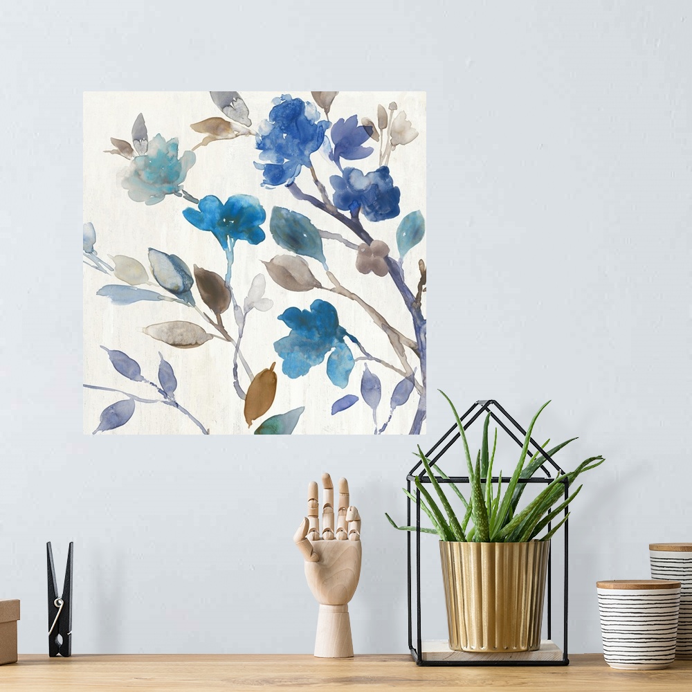A bohemian room featuring Watercolor decorative artwork of blue flowers with brown and pale green leaves on an off-white ba...