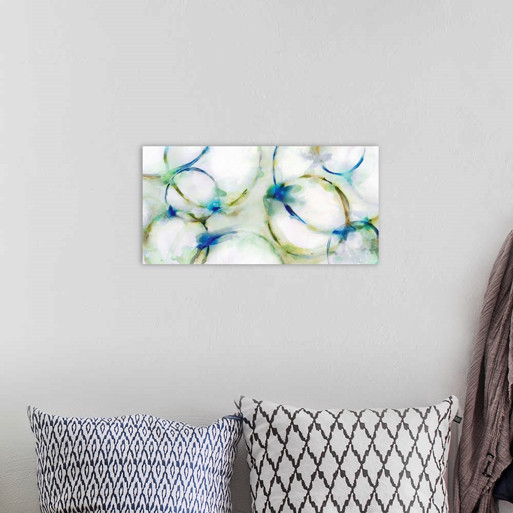 A bohemian room featuring Large abstract painting of distorted circular shapes that fade into the white background.