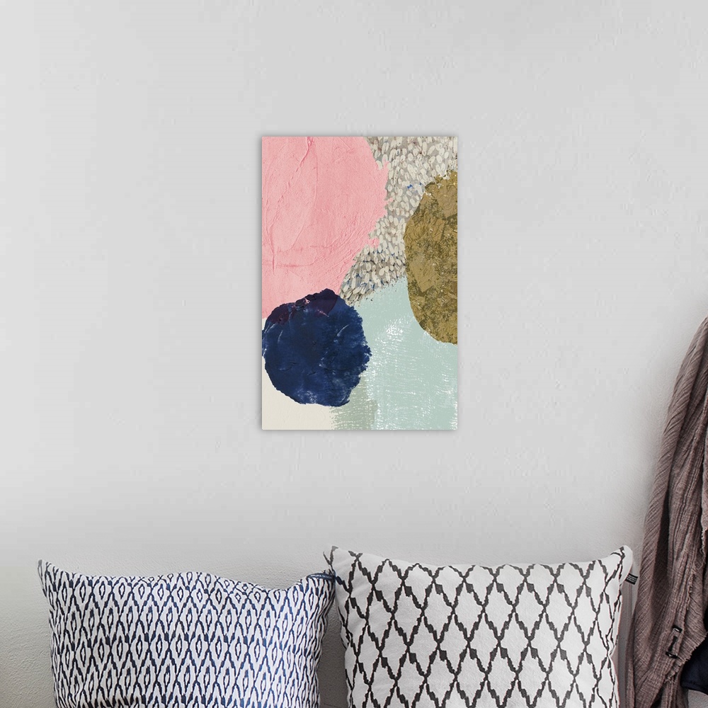 A bohemian room featuring Abstract artwork with circular shapes in dark navy, gold, and pink.