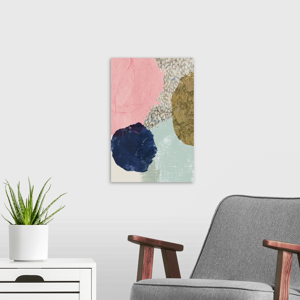 A modern room featuring Abstract artwork with circular shapes in dark navy, gold, and pink.