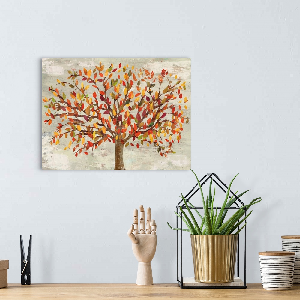 A bohemian room featuring Artwork of a tree with leaves in autumn colors.