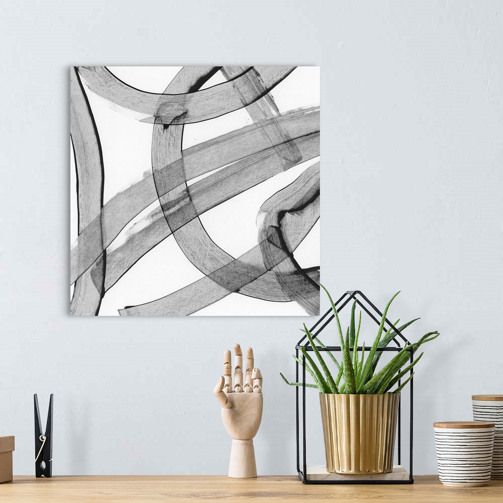 A bohemian room featuring Abstract art made of large, swirling grey strokes.