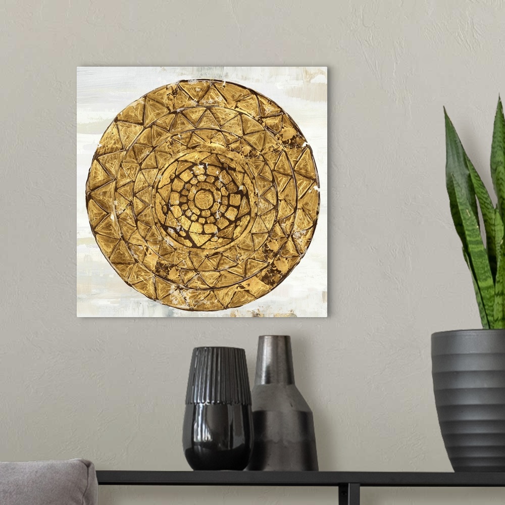 A modern room featuring Square image of a gold circle with textured triangle designs.