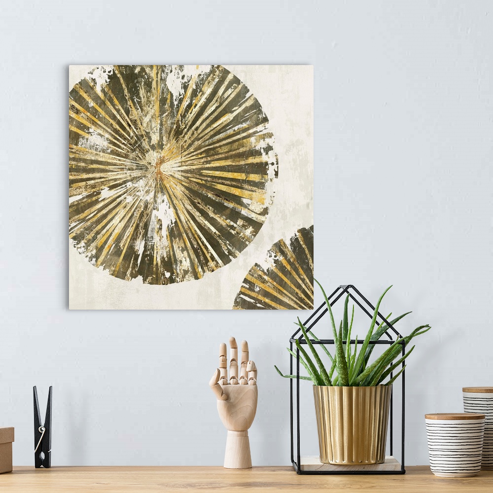 A bohemian room featuring Abstract artwork of circular forms resembling tree rings in gold.
