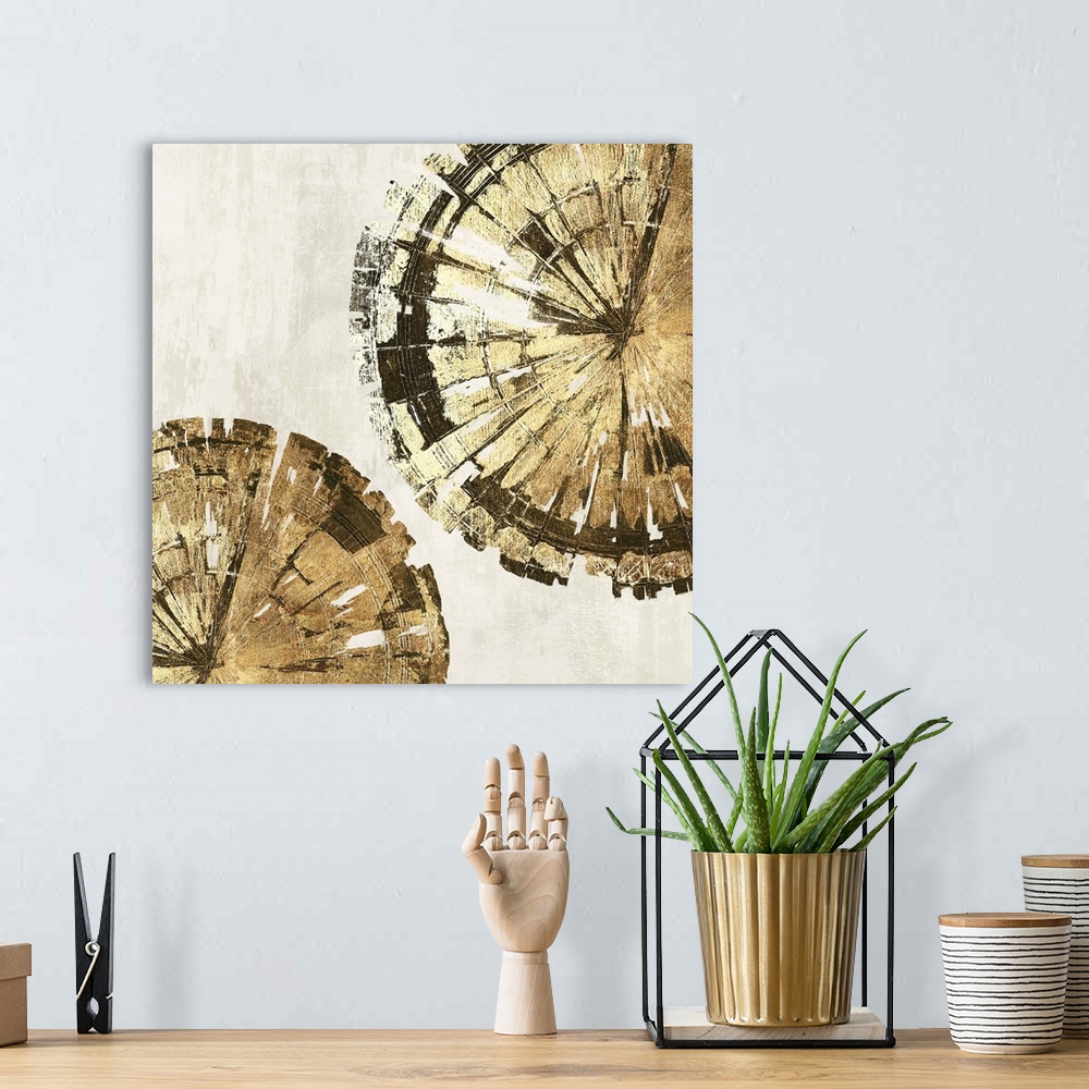 A bohemian room featuring Abstract artwork of circular forms resembling tree rings in gold.