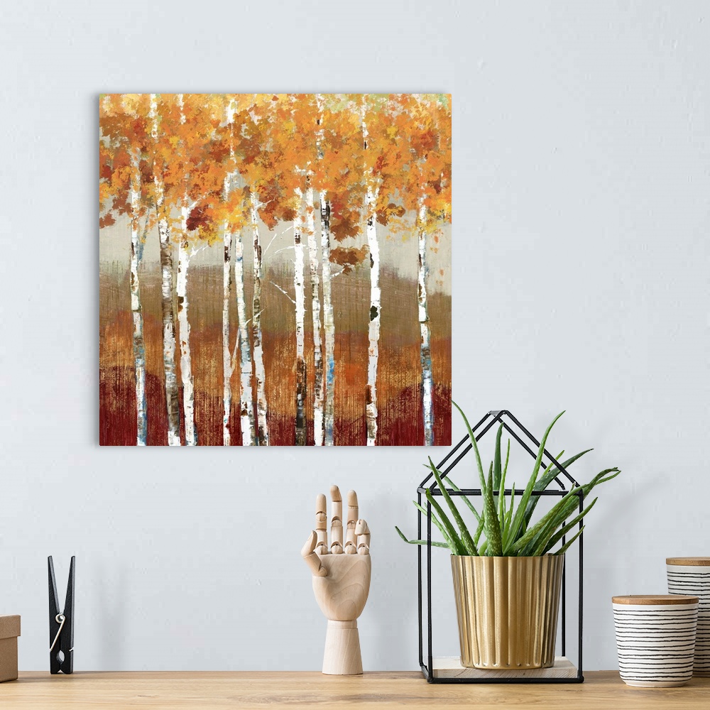 A bohemian room featuring Painting of a group of birch trees with orange leaves in a forest.