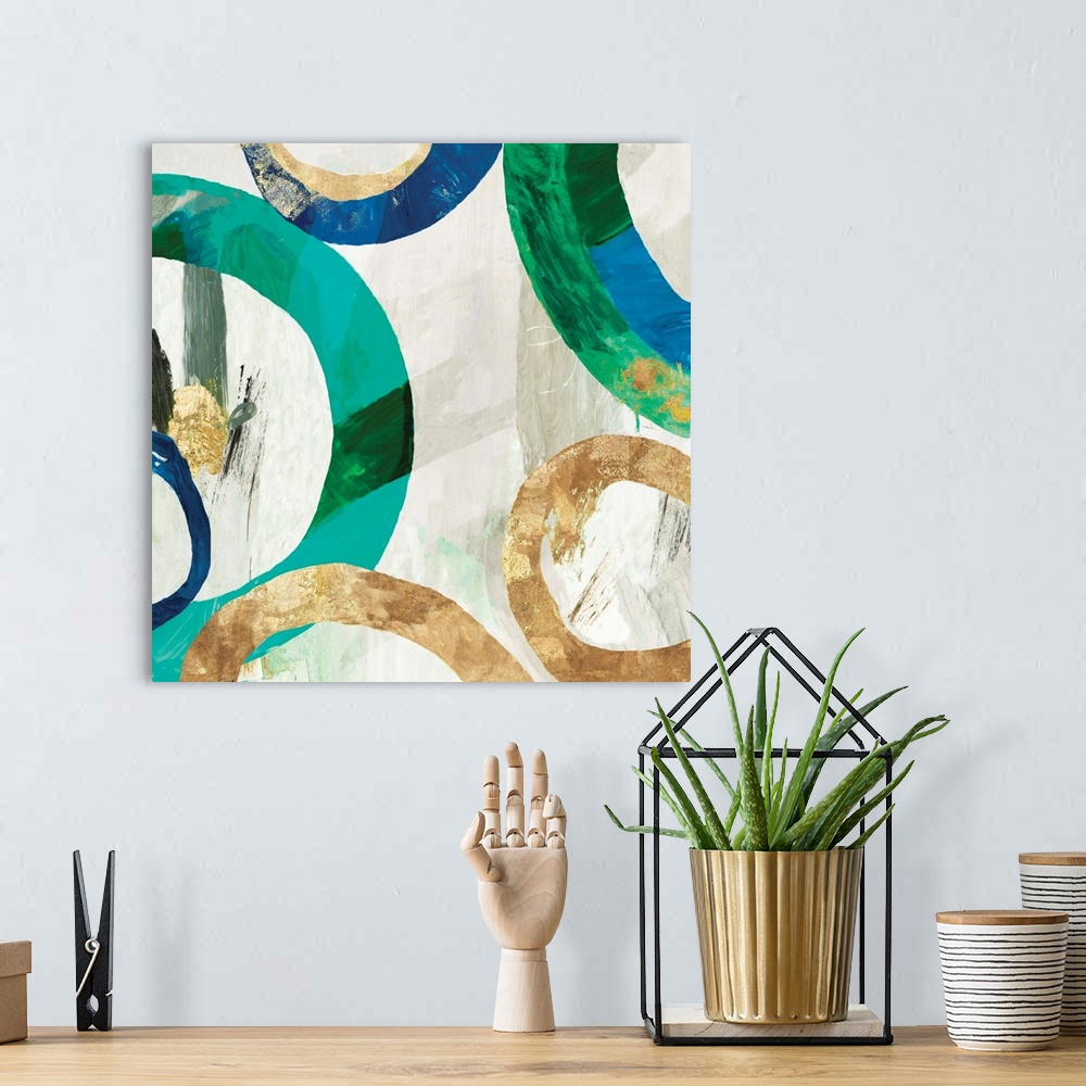 A bohemian room featuring Square abstract decor with rings in different sizes all around in blue, green, and gold hues on a...