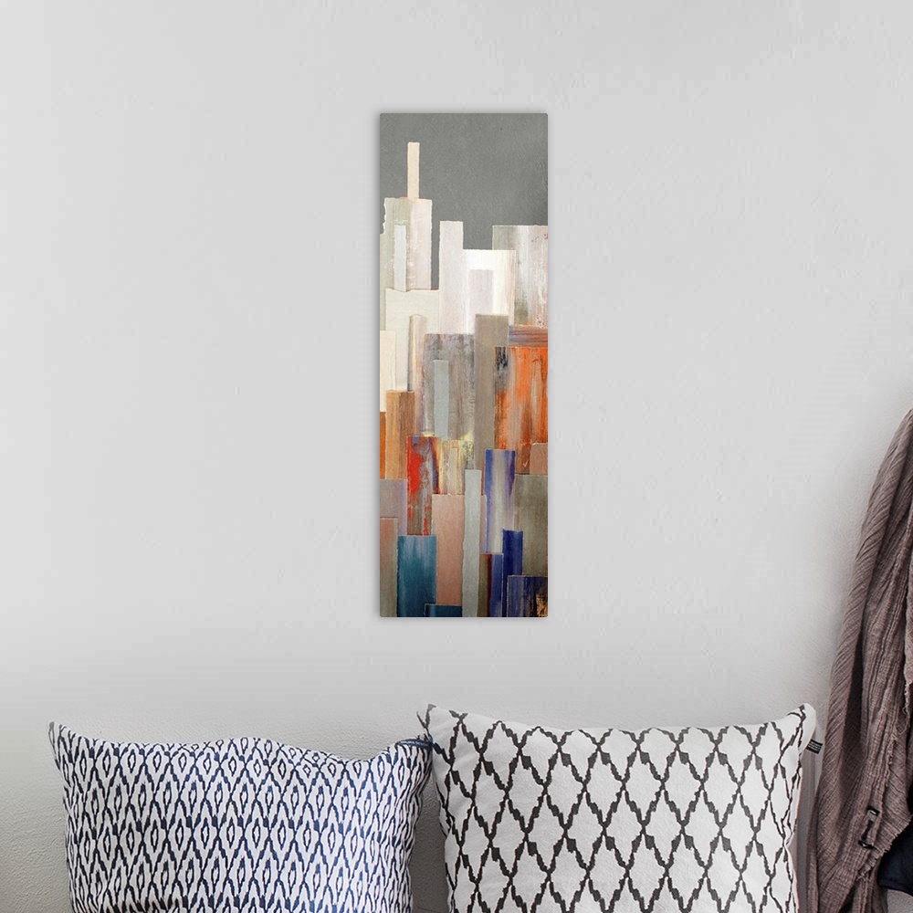 A bohemian room featuring A long vertical contemporary painting of multi colored buildings in a city.