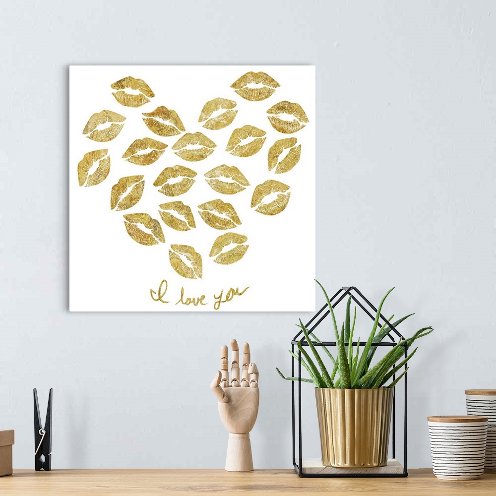 A bohemian room featuring Home decor artwork of gold lettering and a heart made of lip prints against a white background.