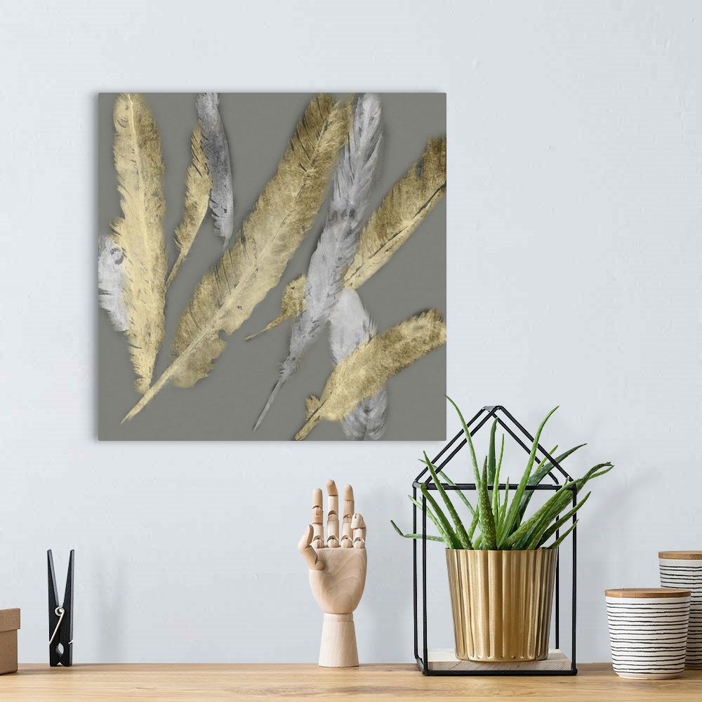 A bohemian room featuring Contemporary home decor artwork of gold and silver feathers fluttering against a gray background.