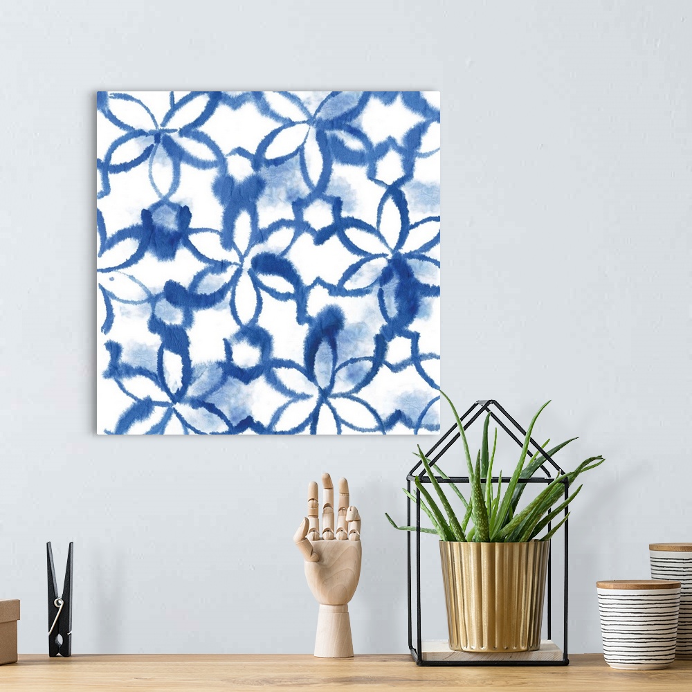 A bohemian room featuring Watercolor artwork of a navy blue Shibori style pattern.