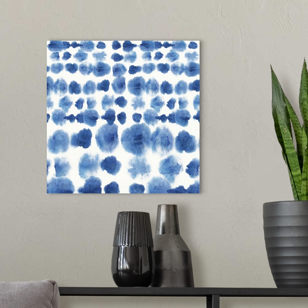 A modern room featuring Watercolor artwork of a navy blue Shibori style pattern.