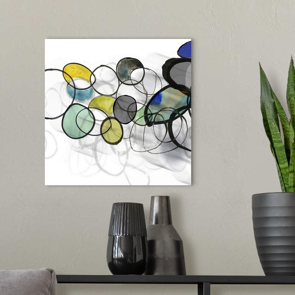 A modern room featuring Square painting of circles and rings in multiple colors with a shadow effect beneath.