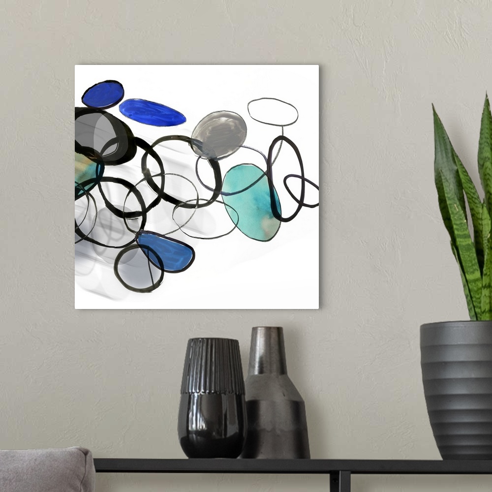 A modern room featuring Square painting of circles and rings in multiple colors with a shadow effect beneath.