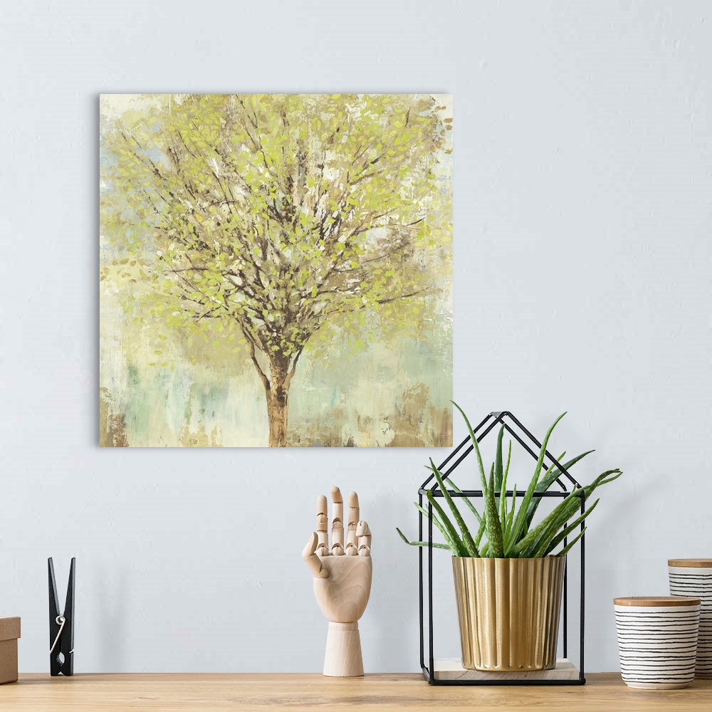 A bohemian room featuring Contemporary artwork of a tree with leafy branches in pale shades of green, blue, and brown.