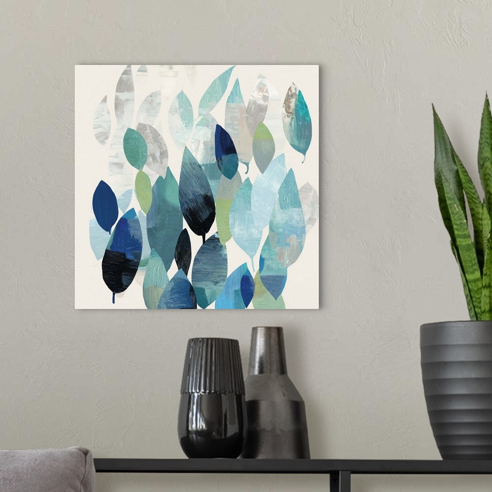 A modern room featuring Square abstract painting of leaves in shades of blue.