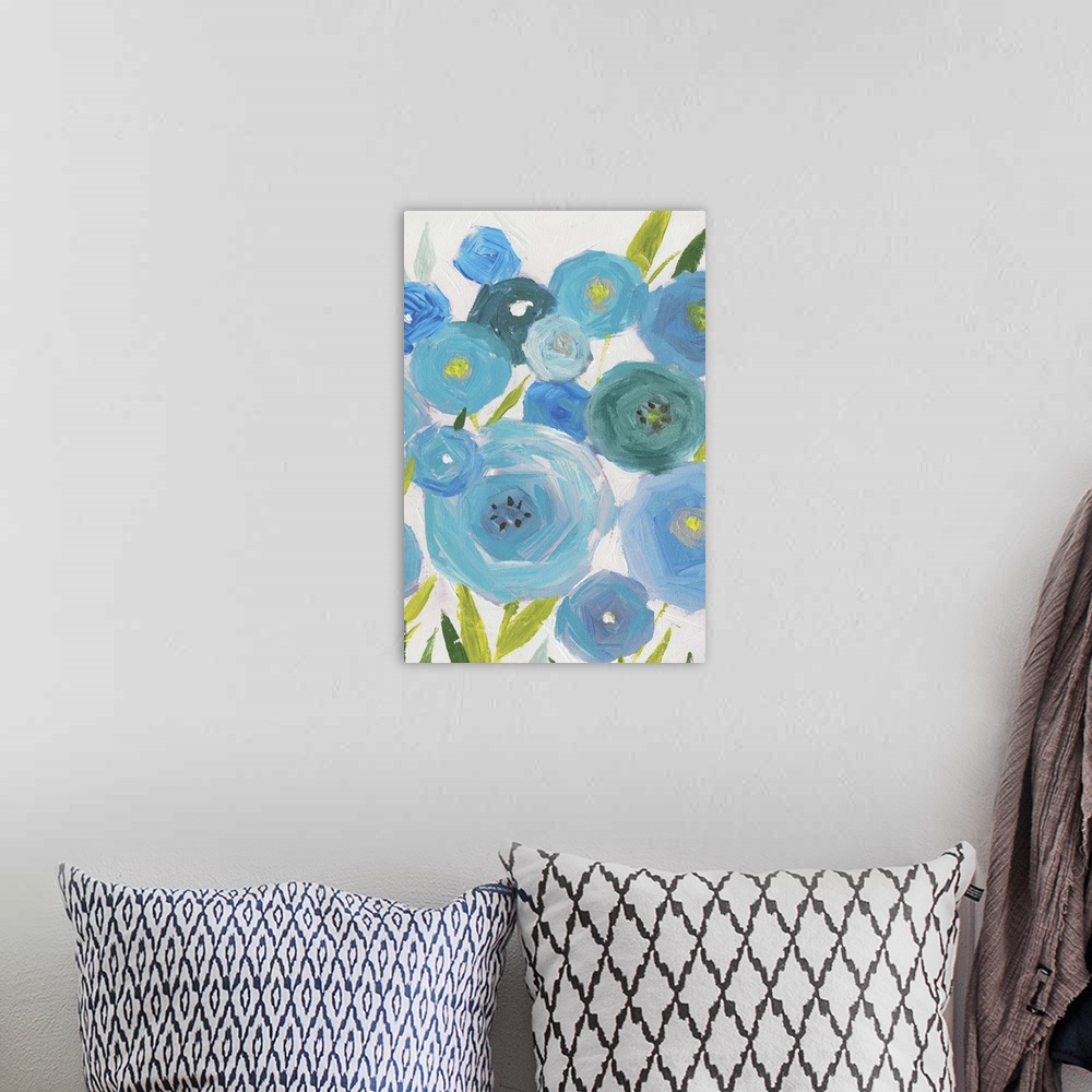 A bohemian room featuring A vertical painting of different shades of blue poppies against a neutral backdrop.