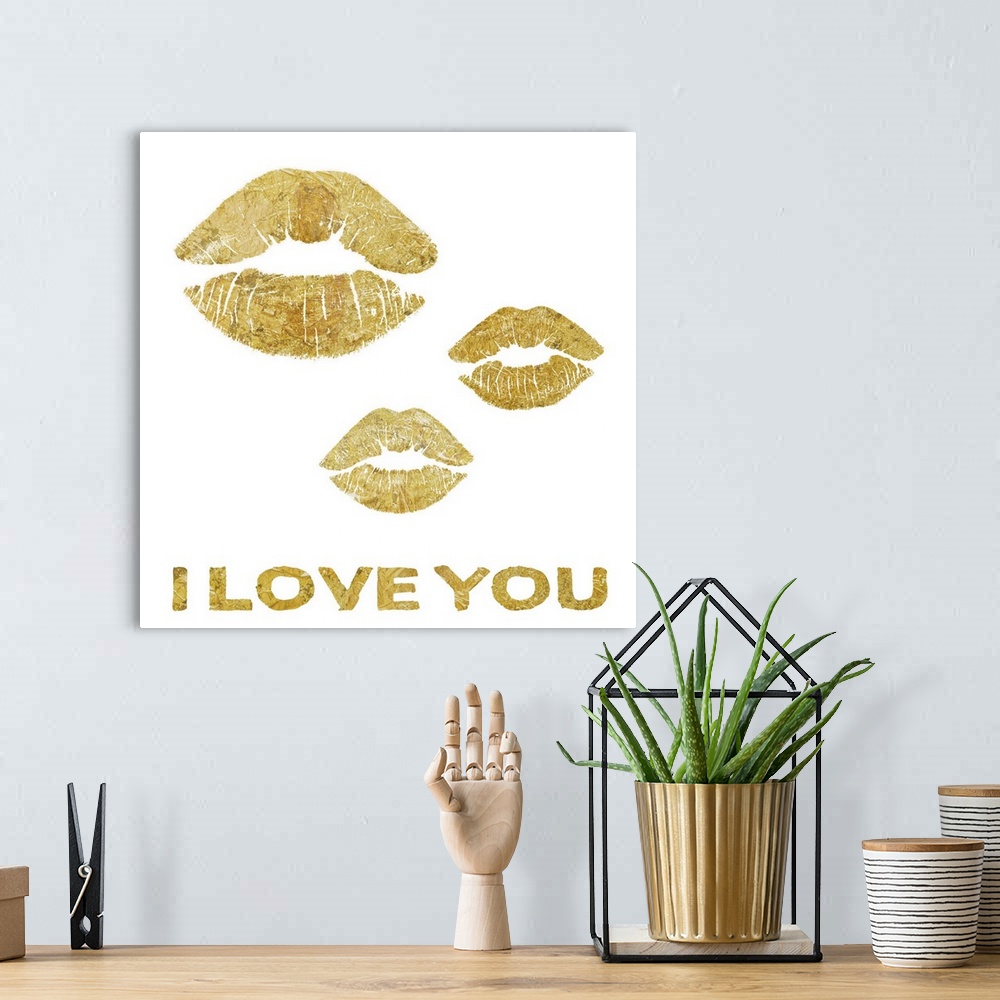 A bohemian room featuring Home decor artwork of gold lettering and lip prints against a white background.