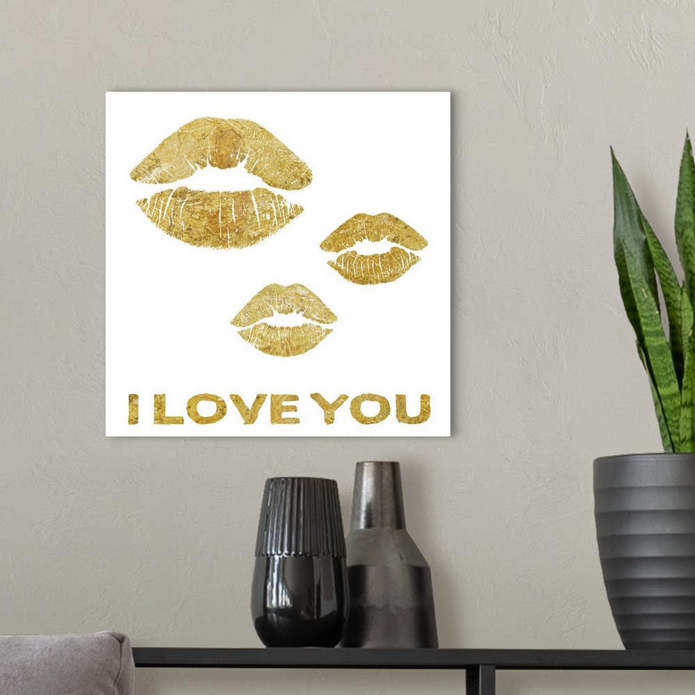 A modern room featuring Home decor artwork of gold lettering and lip prints against a white background.