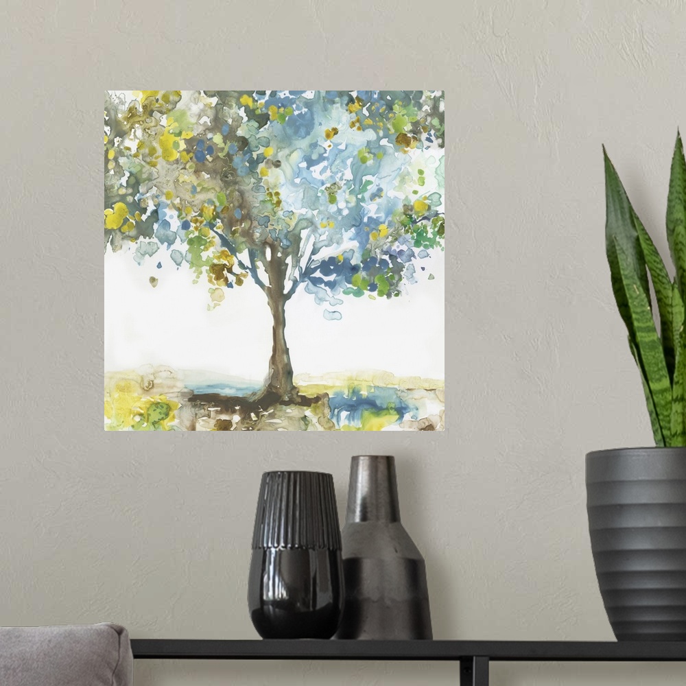 A modern room featuring Square painting of a tree made with blotched blue, brown, green, and yellow hues on a white backg...