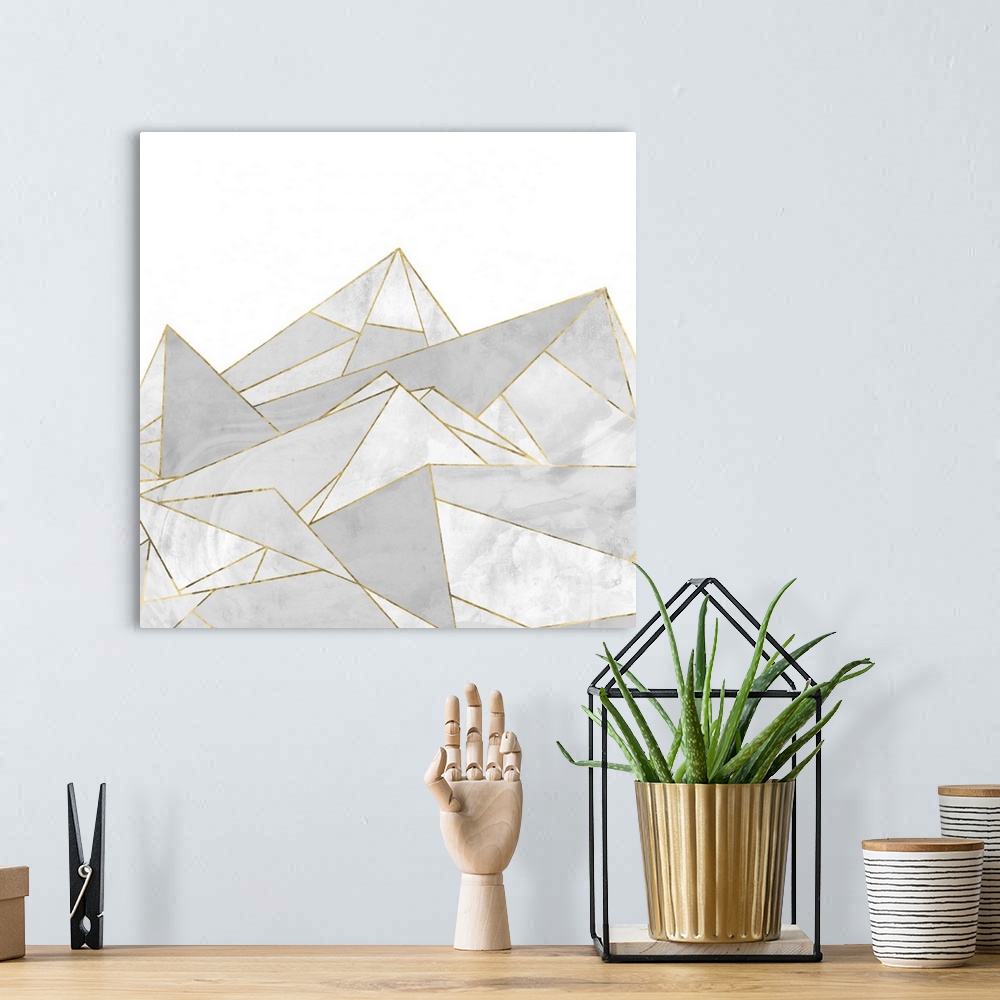 A bohemian room featuring Square painting of gray abstract geometric shapes with gold accents.