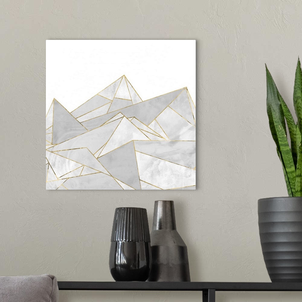 A modern room featuring Square painting of gray abstract geometric shapes with gold accents.