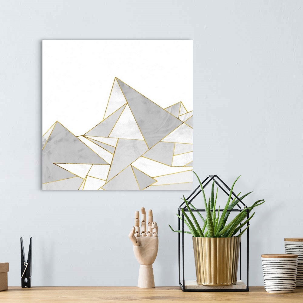 A bohemian room featuring Square painting of gray abstract geometric shapes with gold accents.
