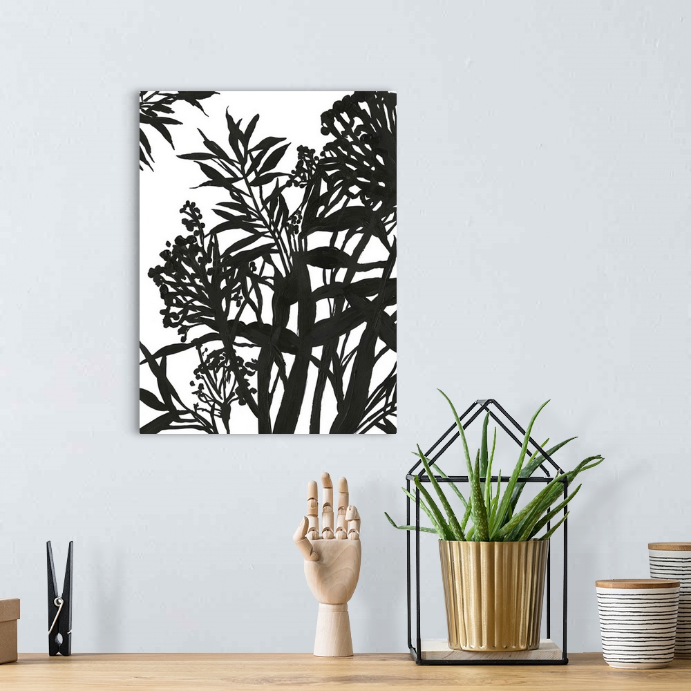A bohemian room featuring Vertical painting of a flower arrangement in black and white.