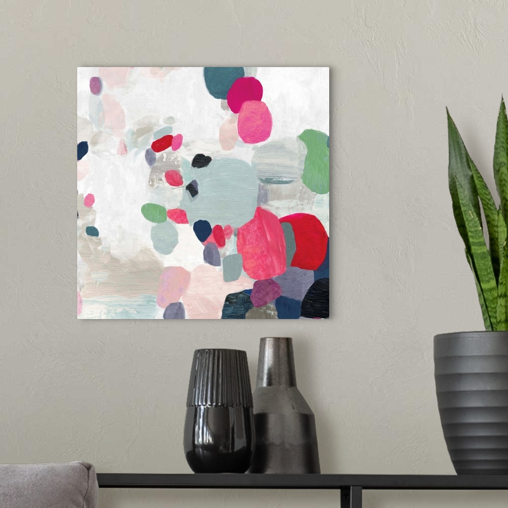A modern room featuring Square painting of varies sized circles in multiple colors on a textured white backdrop.