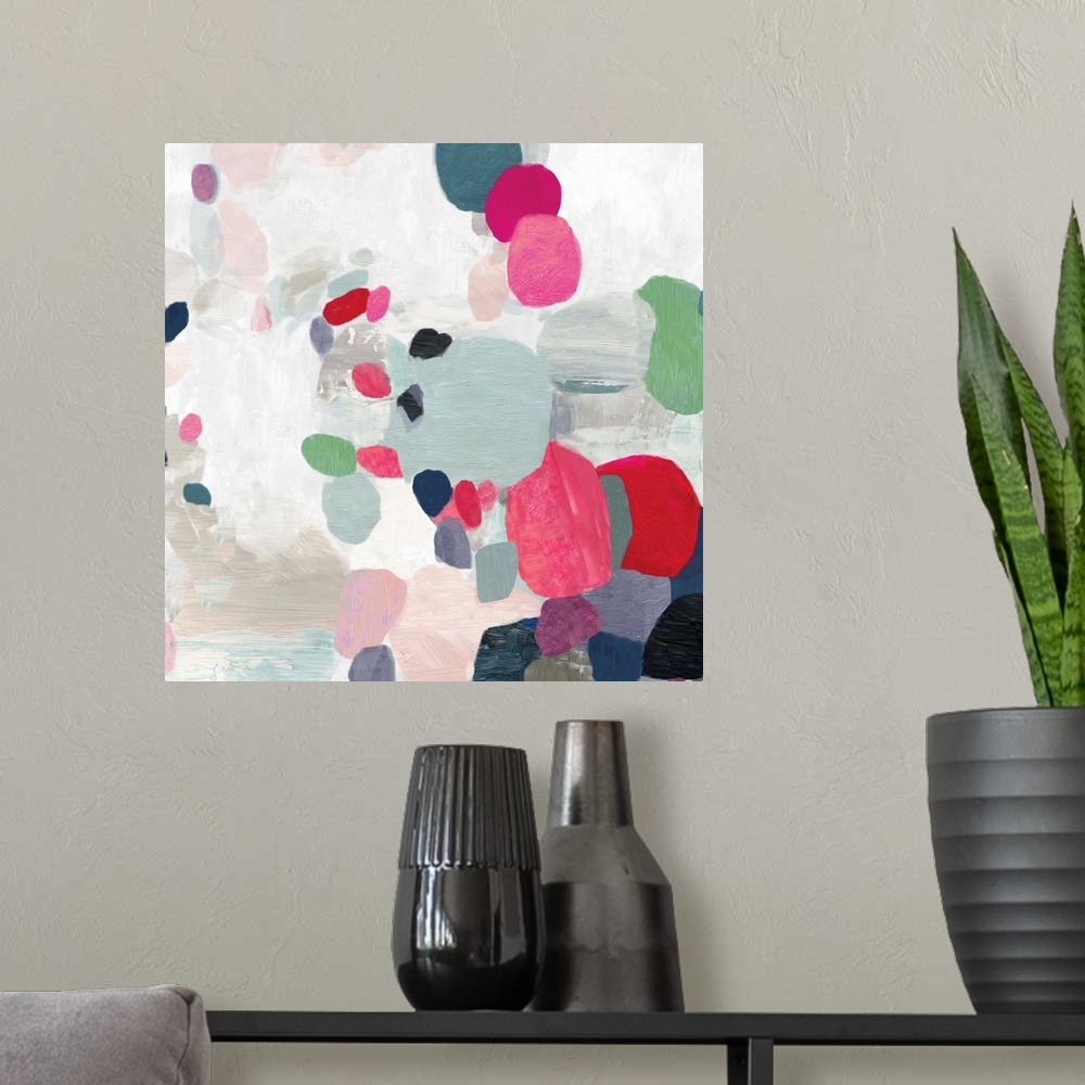 A modern room featuring Square painting of varies sized circles in multiple colors on a textured white backdrop.
