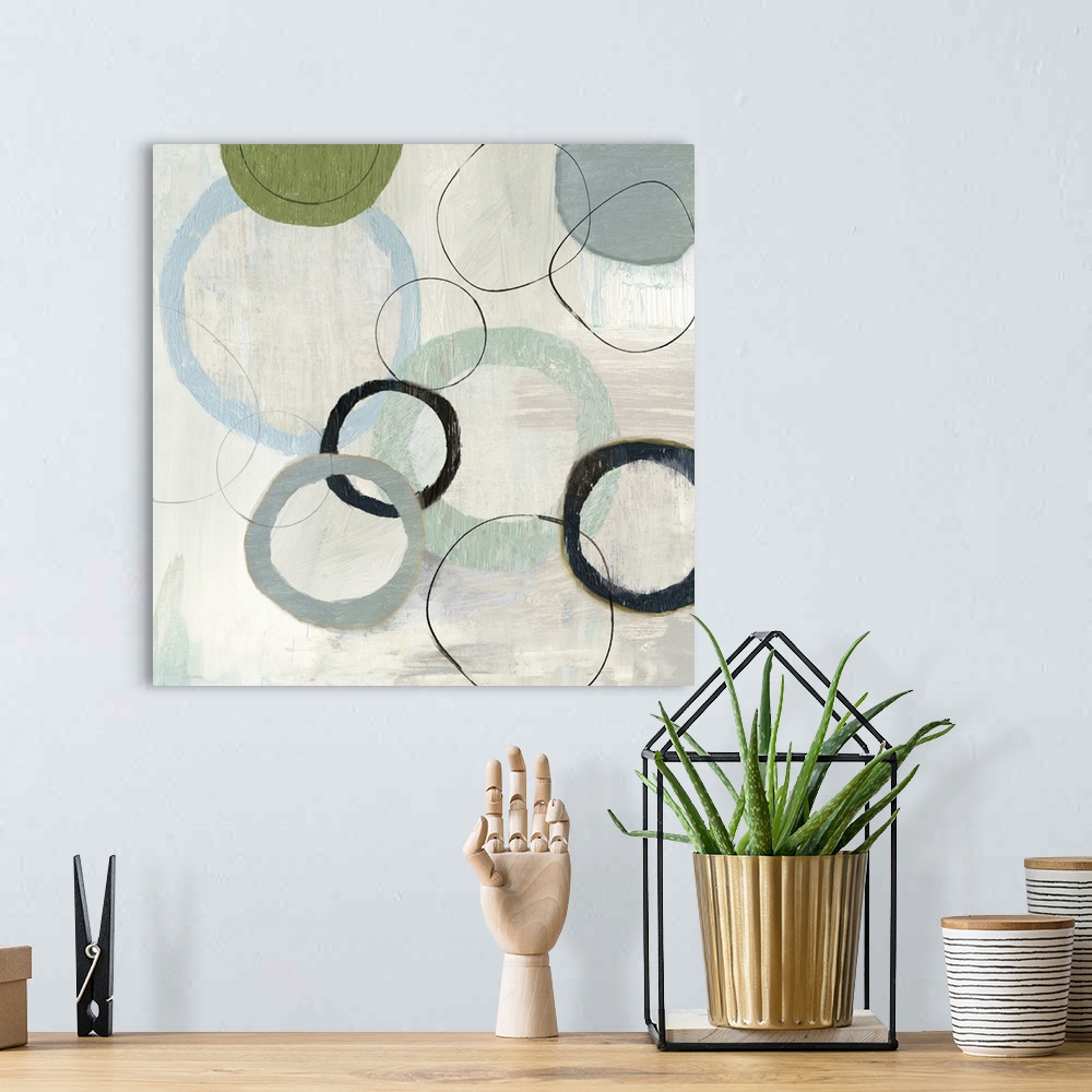 A bohemian room featuring An abstract painting of circles in varies sizes and colors