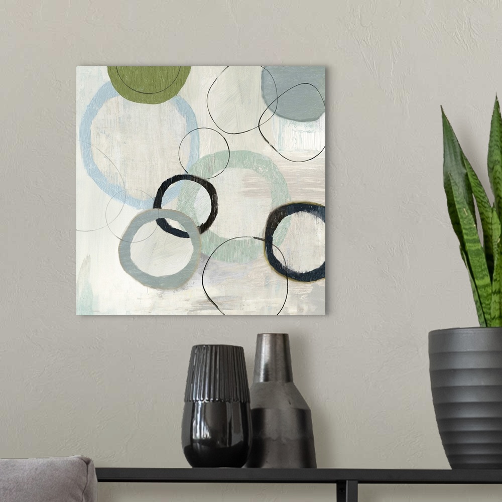 A modern room featuring An abstract painting of circles in varies sizes and colors