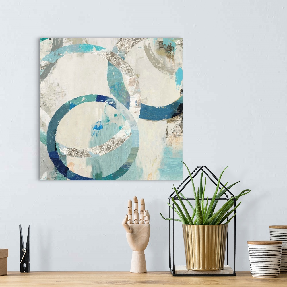 A bohemian room featuring Abstract artwork of overlapping rings in shades of white, cream, and teal.