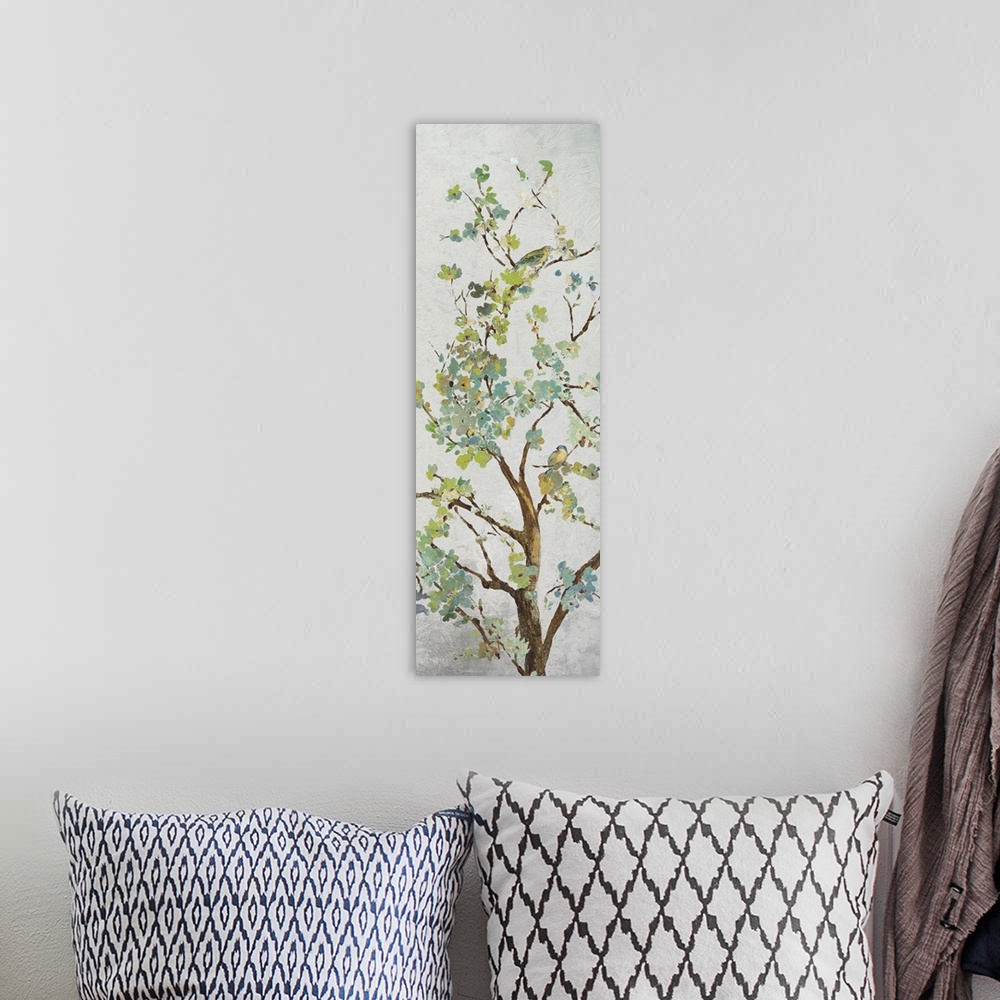 A bohemian room featuring Tree branch with light green leaves on grey.