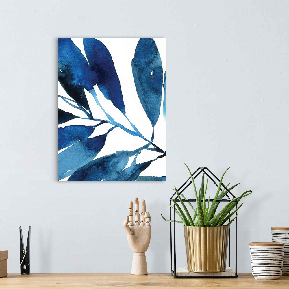 A bohemian room featuring Watercolor painting in shades of deep blue of several leaves on white.