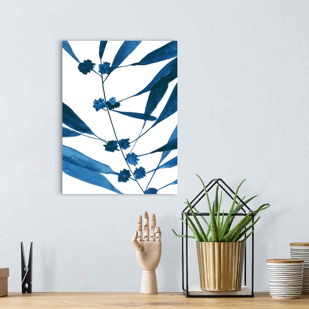 A bohemian room featuring Watercolor painting in shades of deep blue of several leaves on white.
