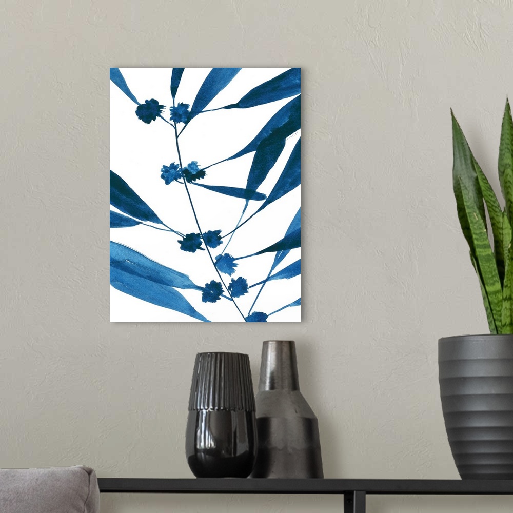 A modern room featuring Watercolor painting in shades of deep blue of several leaves on white.