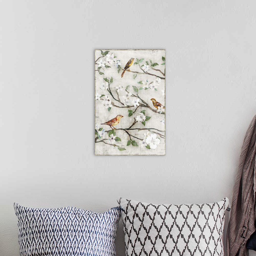 A bohemian room featuring Three small birds perched on branches with white blossoms.