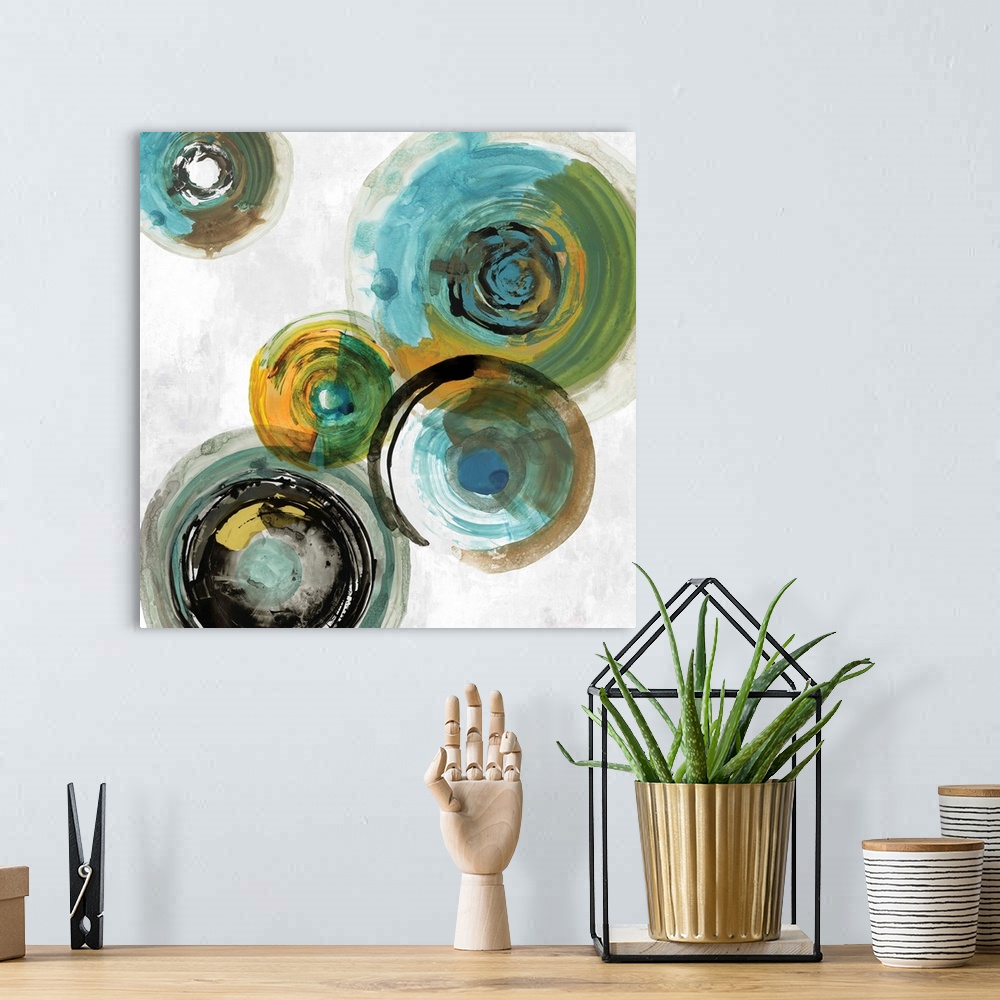 A bohemian room featuring Square contemporary painting of multi- color circles in tones of blue, green and gold.