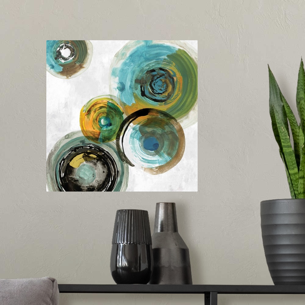 A modern room featuring Square contemporary painting of multi- color circles in tones of blue, green and gold.