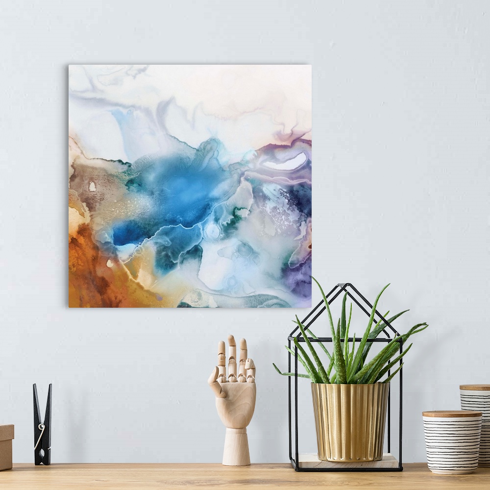 A bohemian room featuring Abstract watercolor artwork of softly blending shades of blue, lavender, and orange.