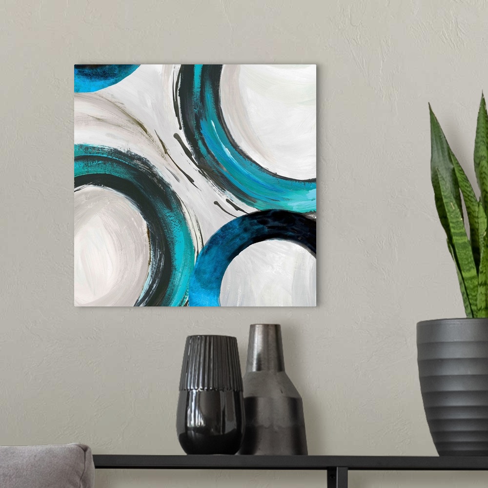 A modern room featuring Abstract artwork with wide turquoise rings on white.