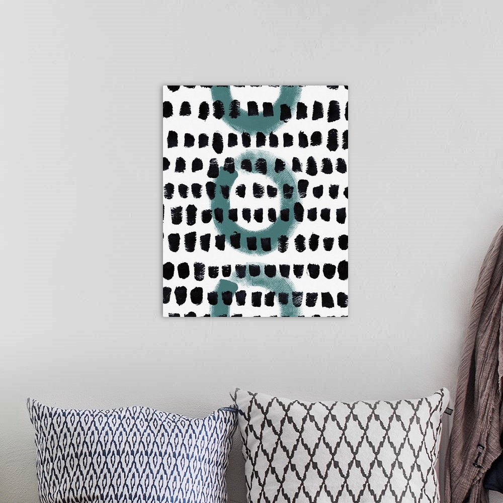 A bohemian room featuring Abstract painting of circles and textured dots in a pattern.